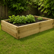 Wooden raised garden bed with plants on a grassy area