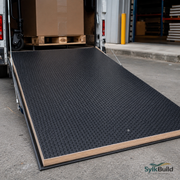 Black loading ramp being used to unload a pallet of boxes from a van, with 'SylkBuild' branding visible.