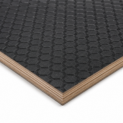 Close-up of a black honeycomb-patterned mat with a wooden border on a white background